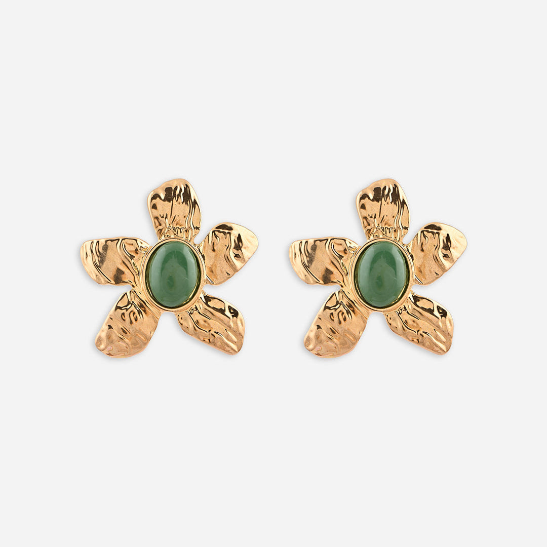 Gold flower-shaped earrings with green stones on a white background