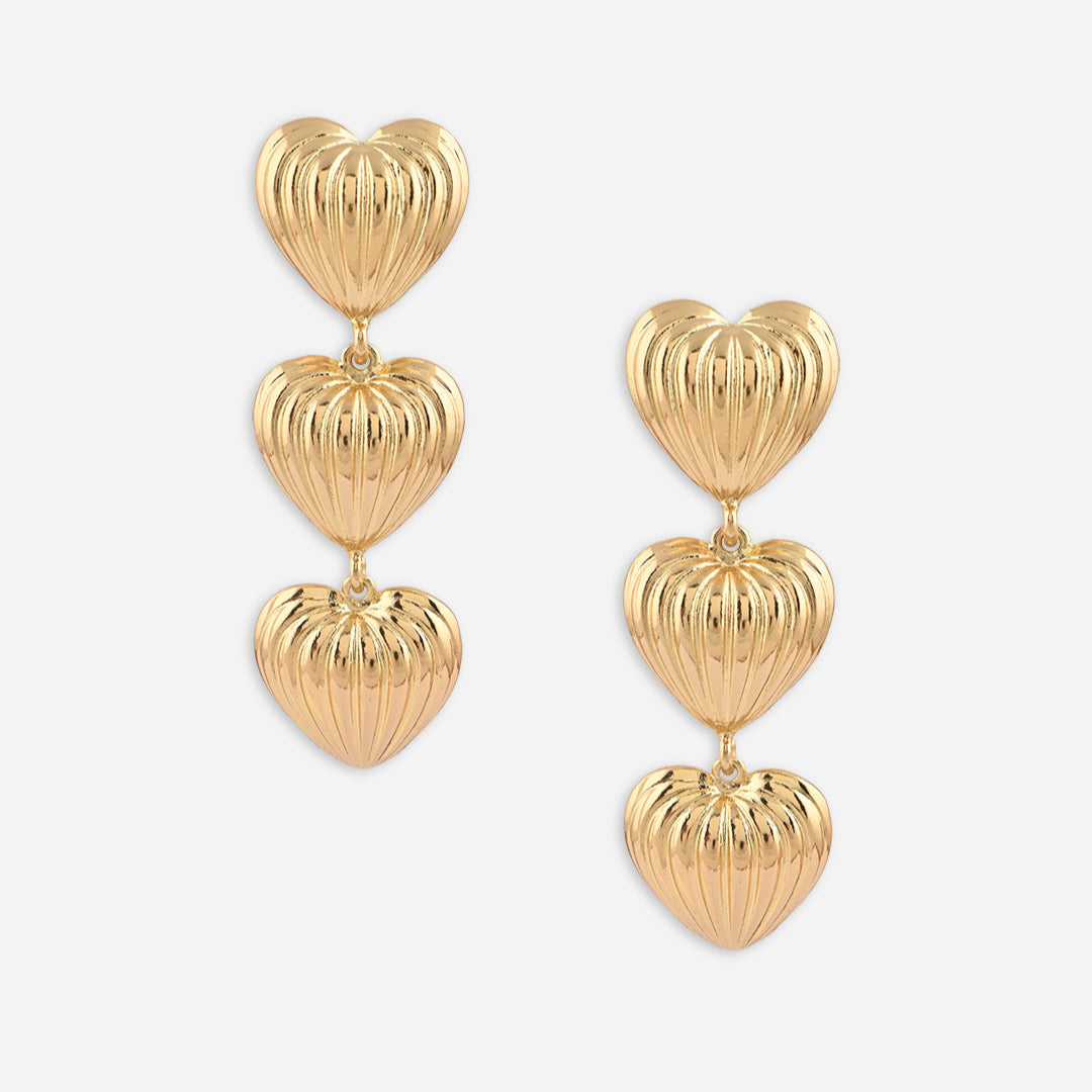 Gold heart-shaped earrings on a white background