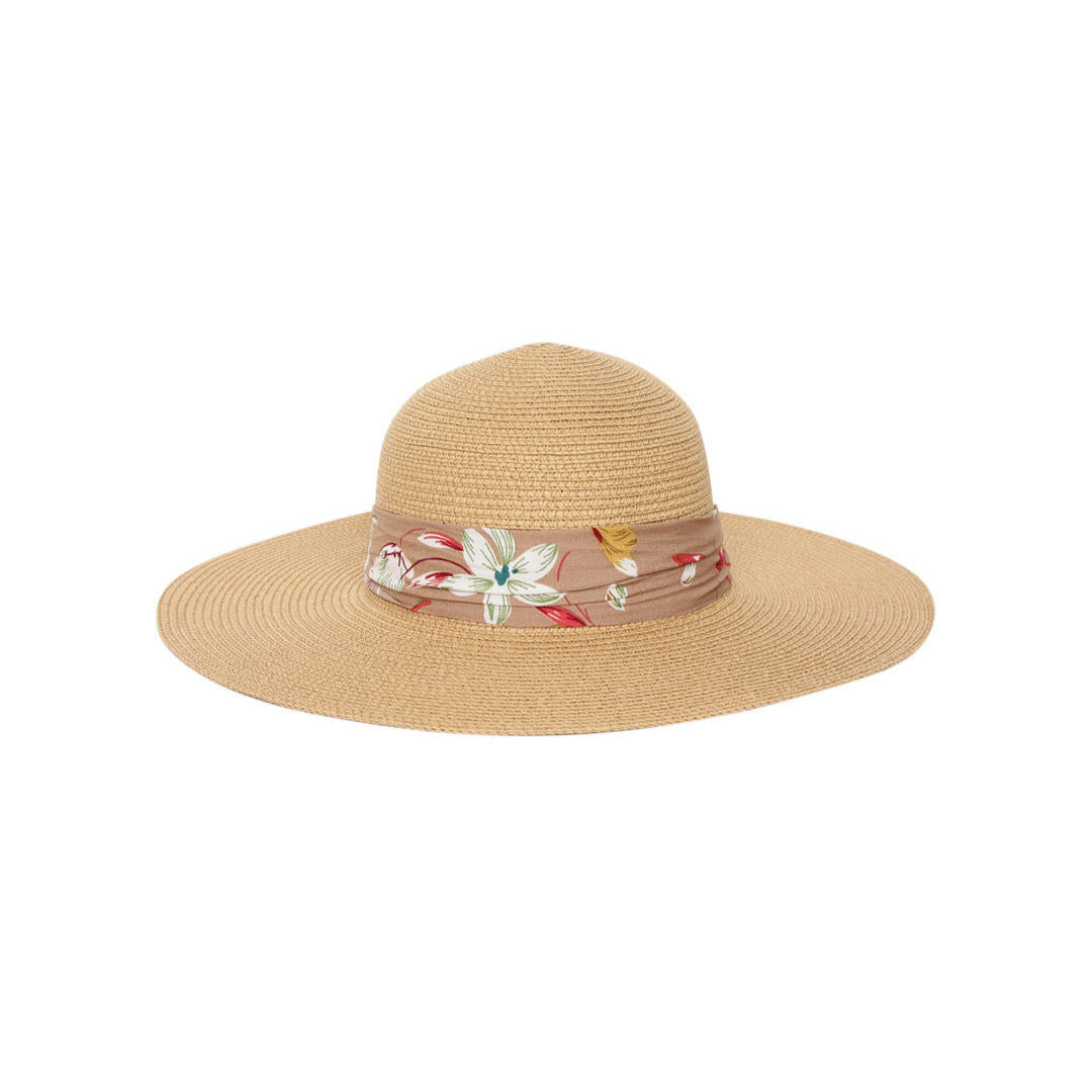 A beige beach hat with a soft brown multicolor floral printed scarf around the base.