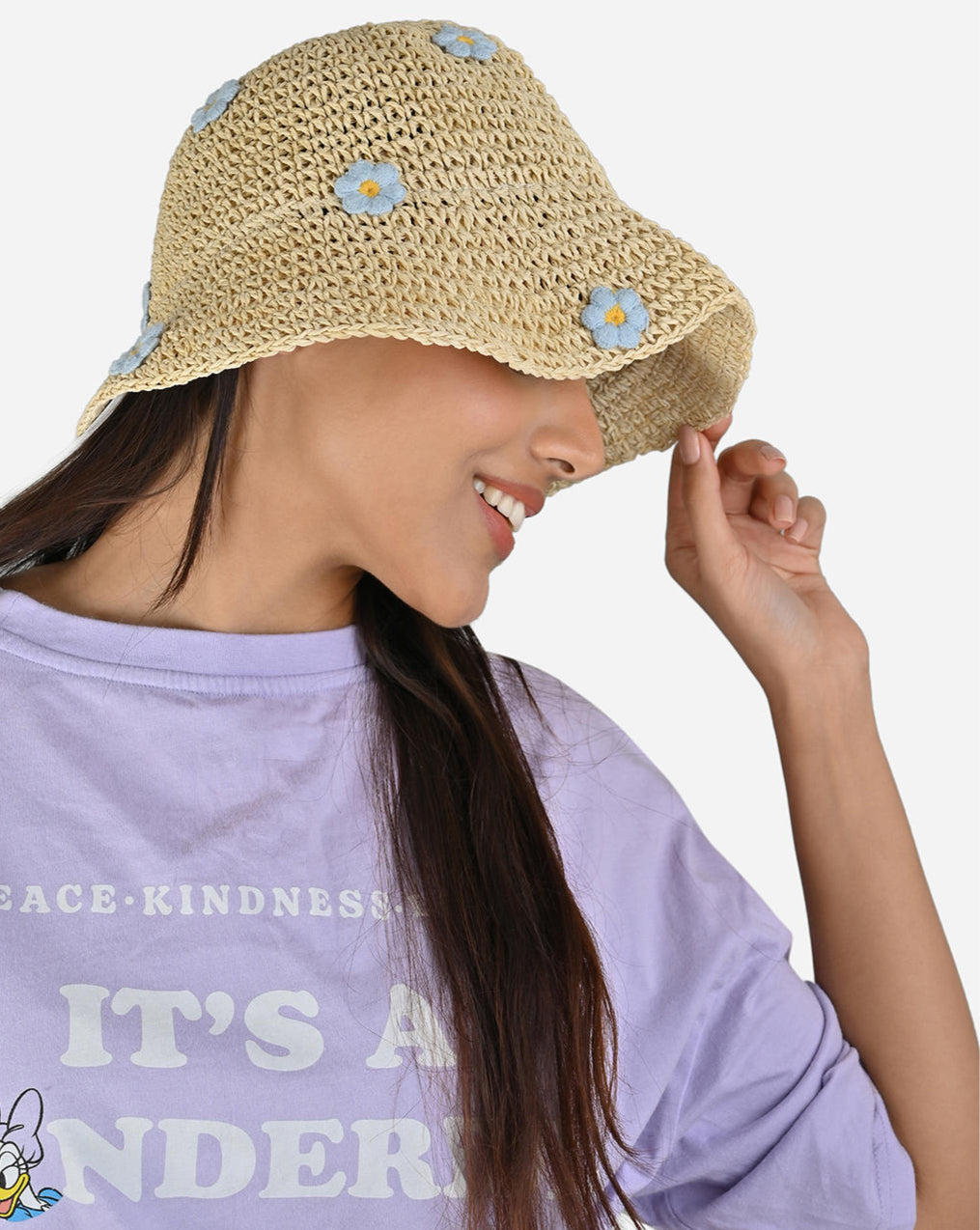 model wearing Woven straw hat with floral embellishments on a white background
