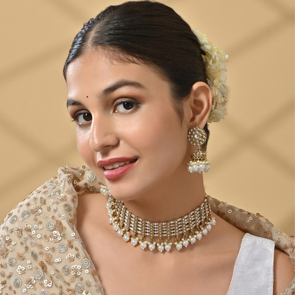 a white pearl and gold statement choker necklace and matching earrings set