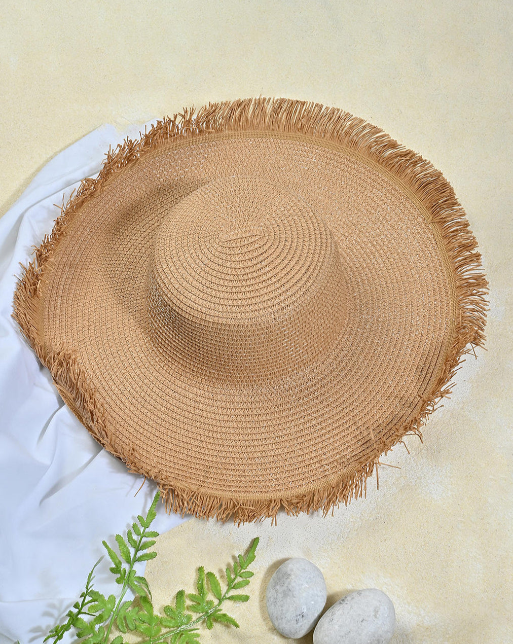 Round woven placemat with fringed edges on a white background