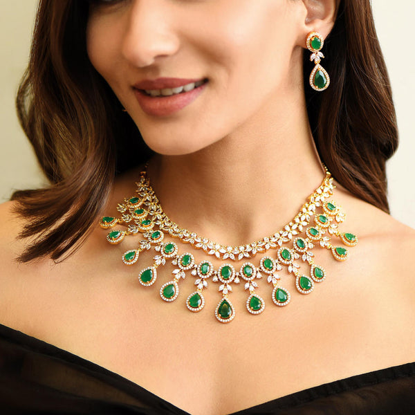 Model wearing Fida Luxurious American Diamond and Green Stone Layered Jewellery Set with necklace and earrings, handcrafted bridal wedding jewellery