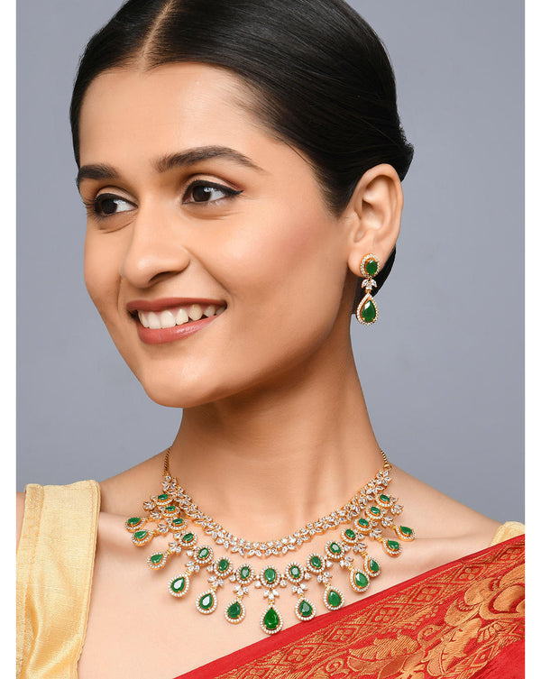 Model Wearing Fida Luxurious American Diamond and Green Stone Layered Jewellery Set with necklace and earrings, handcrafted bridal wedding jewellery