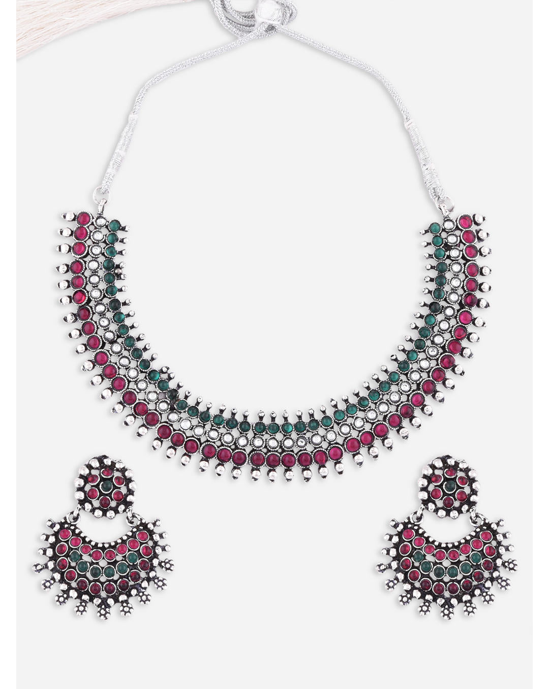 A South Indian traditional silver choker necklace and earrings set with marron and kundan embellishments.