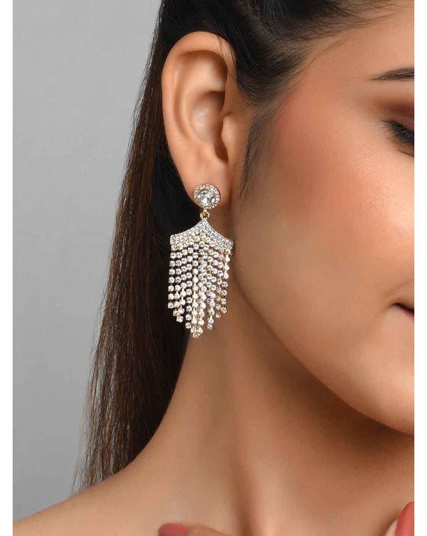 A woman wearing a gold-plated geometric drop earring featuring white artificial stones. ToniQ jewellery is skin safe, nickel free, cadmium free, hypoallergenic, and lab tested for your comfort and trust.
