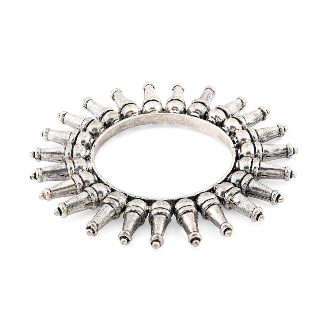 A silver-plated oxidized tribal kada bangle with a rays pattern
