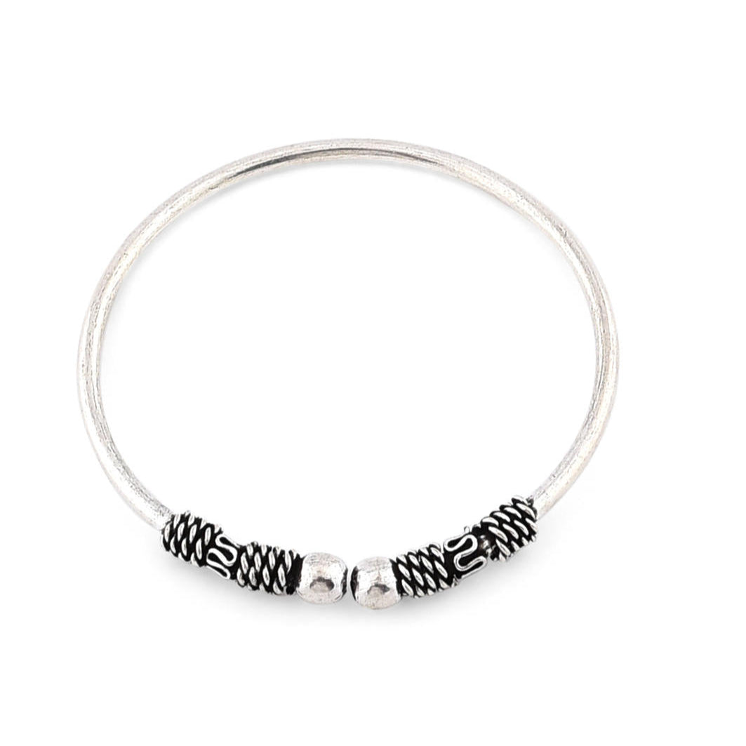 A silver-plated oxidised bangle set, featuring intricate detailing and a textured look.