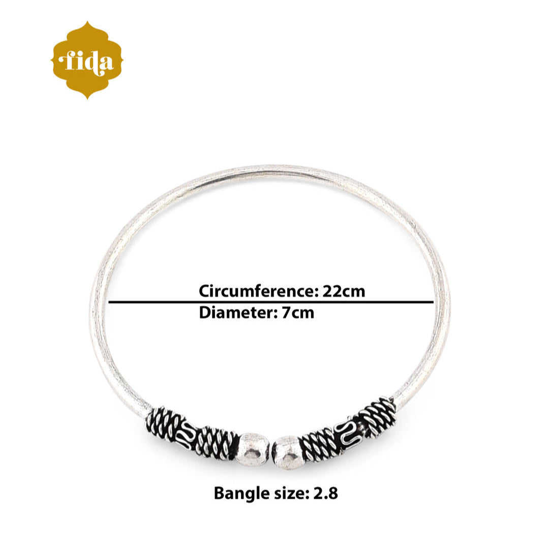 A silver-plated oxidised bangle set, featuring intricate detailing and a textured look. Dimension of the Product.