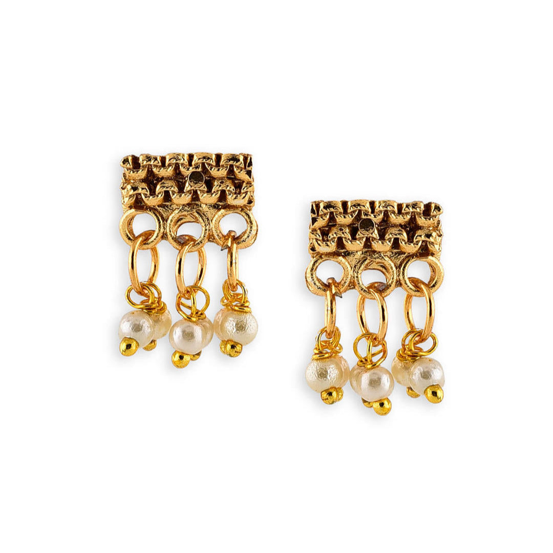 a gold-plated earring with white beads, showcasing a piece of temple jewellery.
