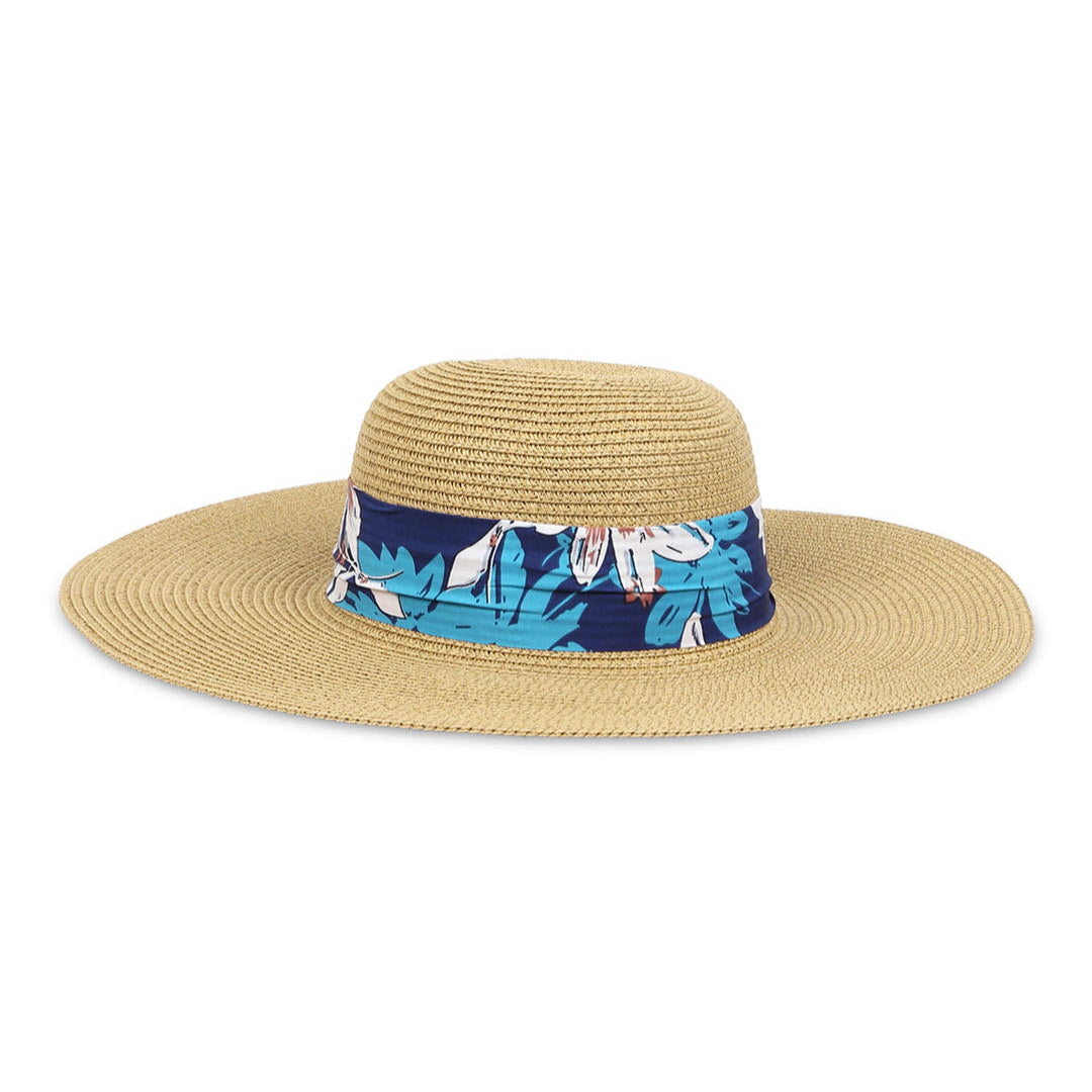 A straw beach hat with a navy printed scarf around the brim