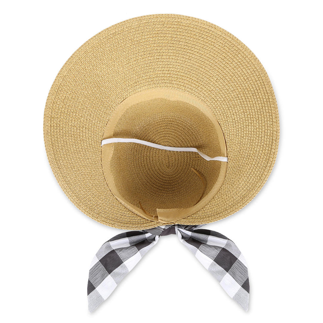 A beige beach hat with a black-and-white checked scarf tied around the base.