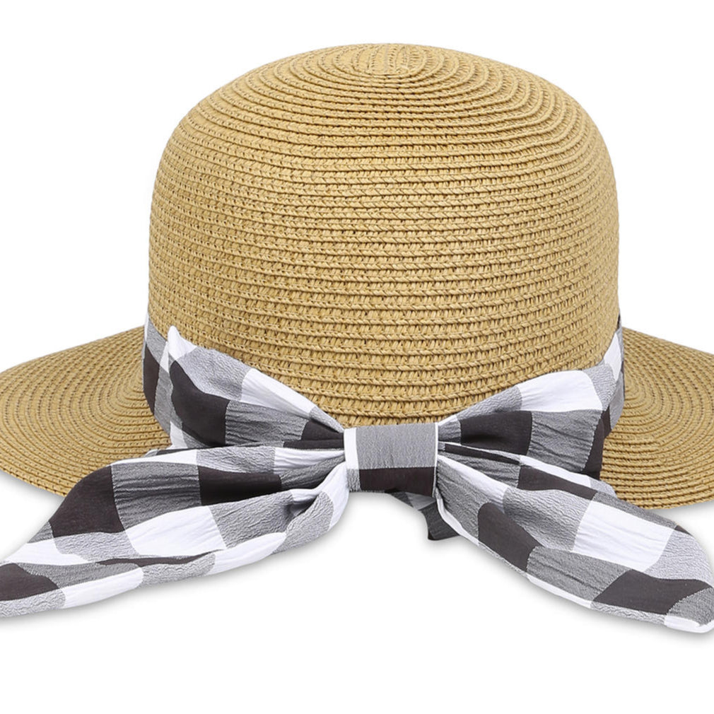 A beige beach hat with a black-and-white checked scarf tied around the base.