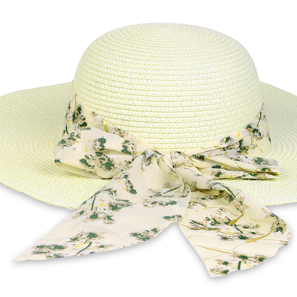 A white beach hat with an ivory floral scarf tied around the brim.