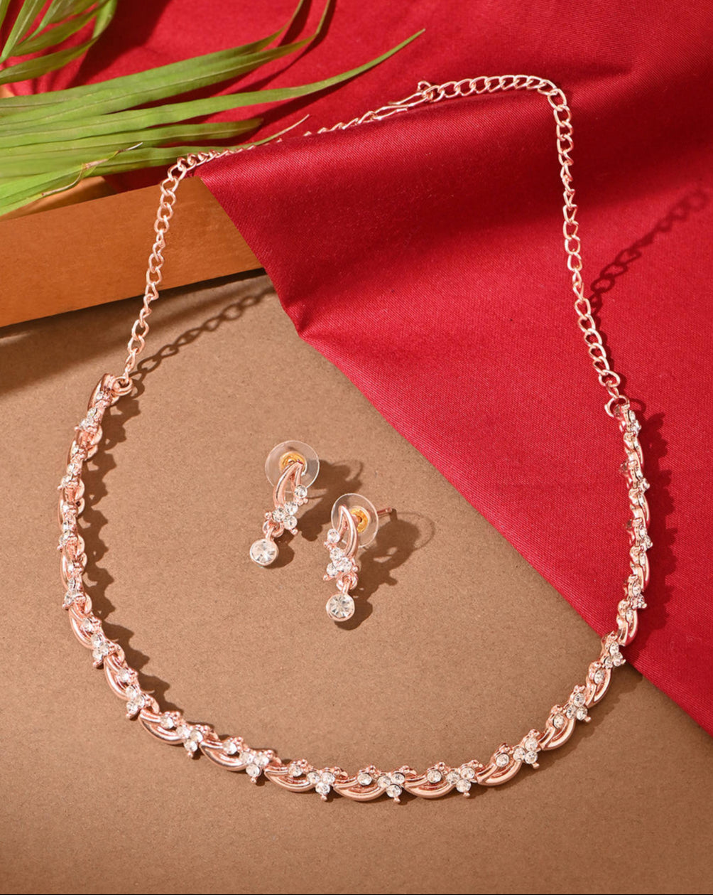 luxurious rose gold and American diamond floral party jewellery set, including a necklace and earrings.