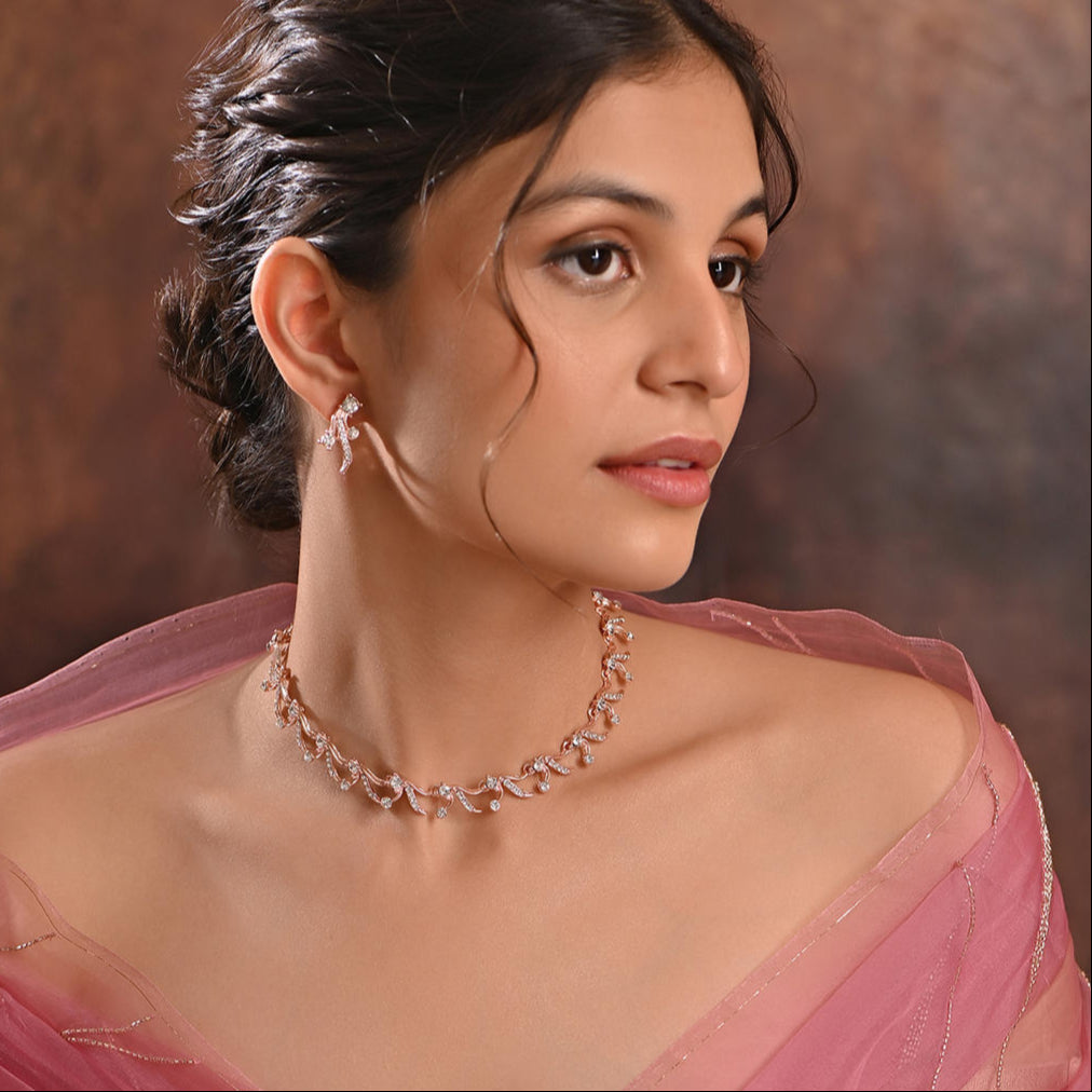 a rose gold floral party necklace and earrings set with sparkling stones.