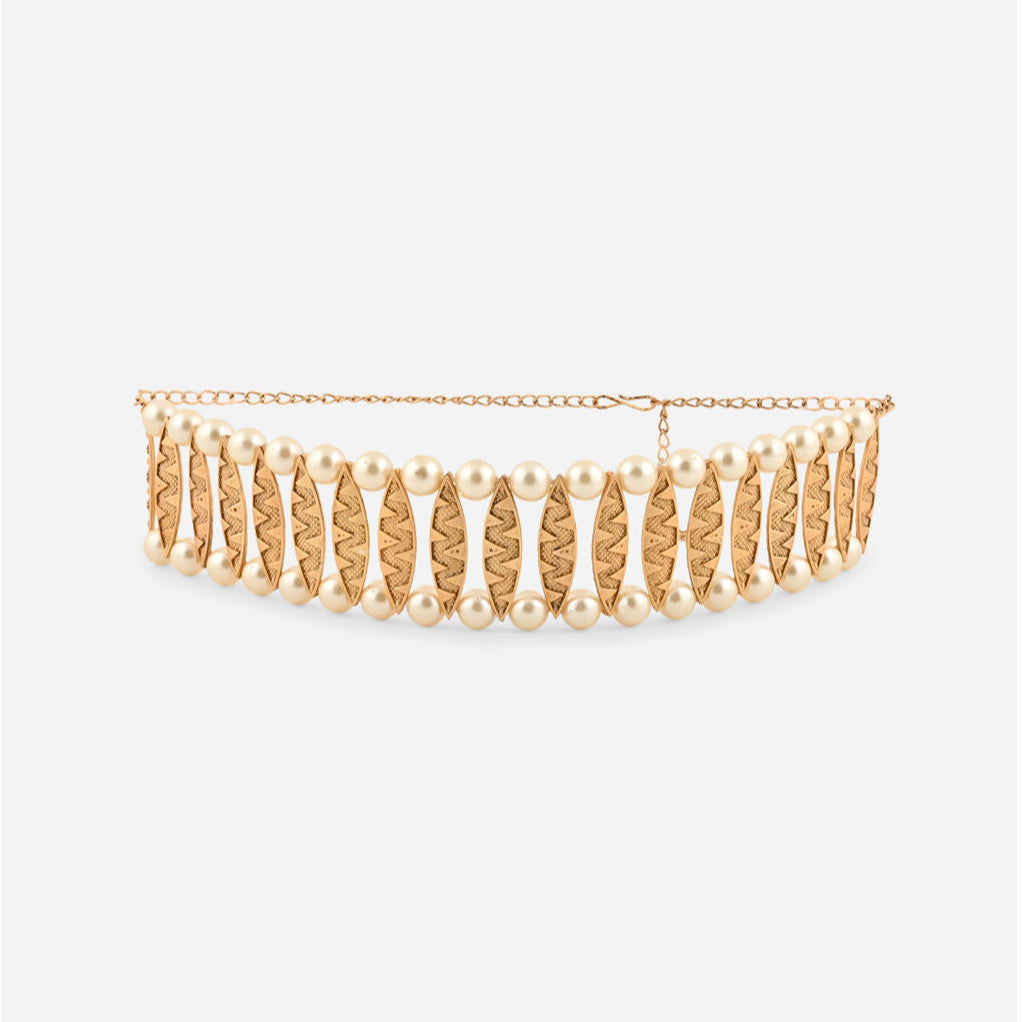 a gold-plated pearl choker necklace and matching earrings from the Fida brand. The jewelry features intricate gold detailing and lustrous pearls.