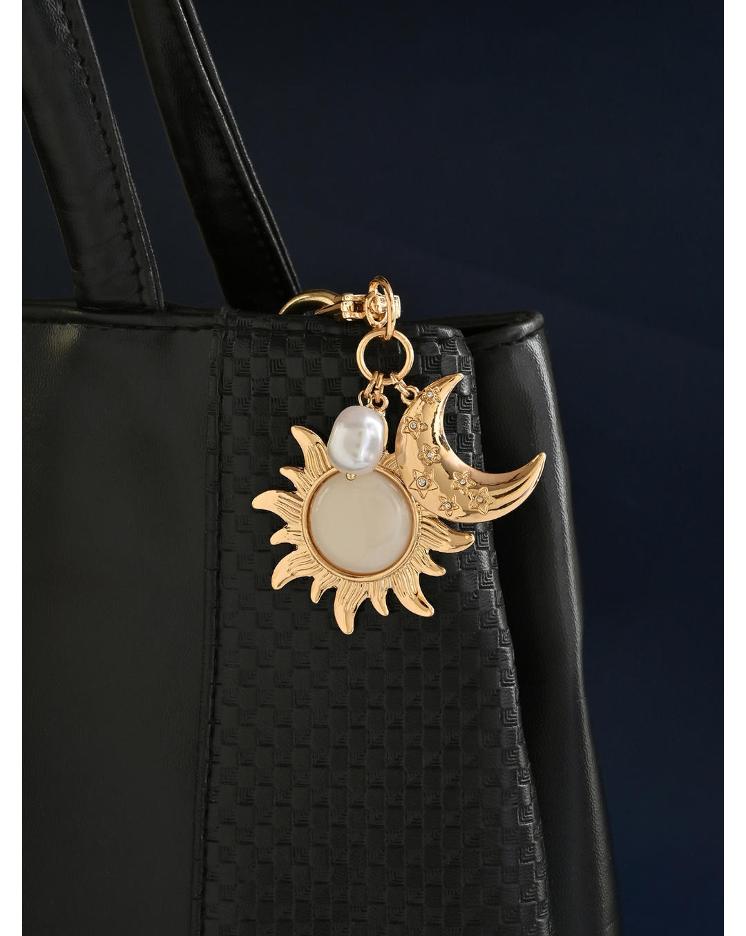 Gold keychain with sun, moon, and pearl charm