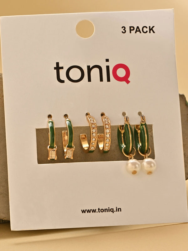 Toniq earrings packaging with three pairs of earrings on a beige background