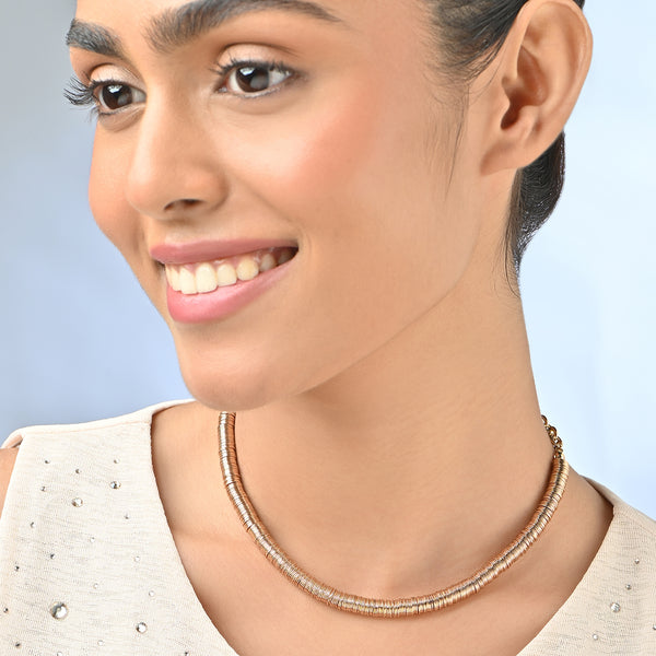Woman wearing a necklace with a light blue background. ToniQ jewellery is skin safe, nickel free, cadmium free, hypoallergenic, and lab tested for your comfort and trust.