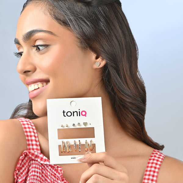 Woman wearing earrings with a toniq product card in the foreground. ToniQ jewellery is skin safe, nickel free, cadmium free, hypoallergenic, and lab tested for your comfort and trust.
