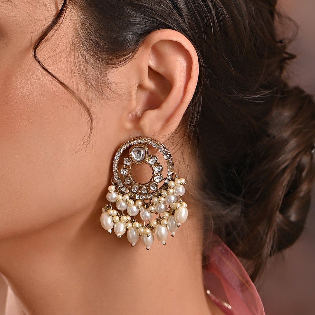 A pair of Radiant Kundan Round Drop Earrings with intricate kundan stonework and lustrous white pearls