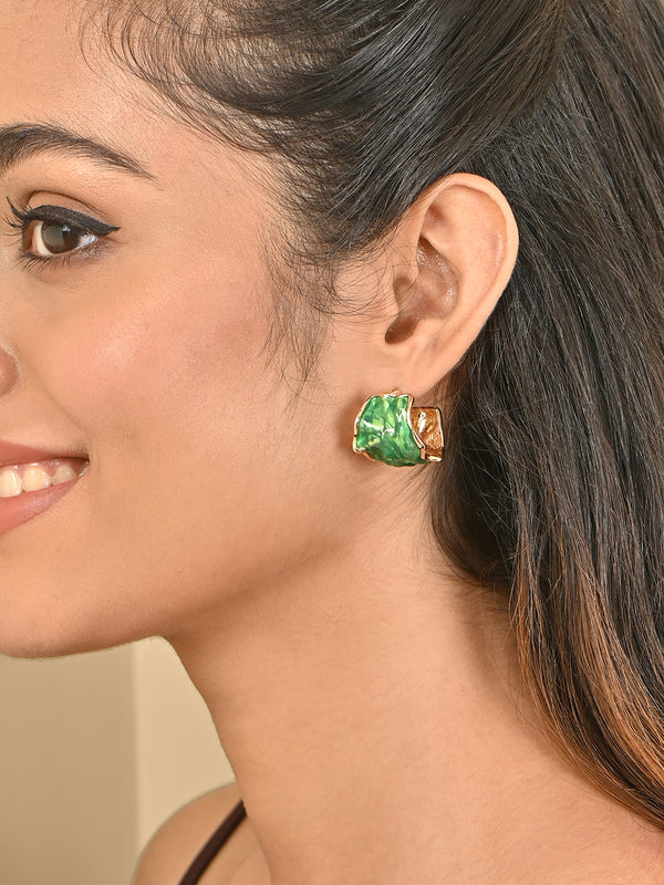Close-up of a woman wearing a green earring with a gold setting.