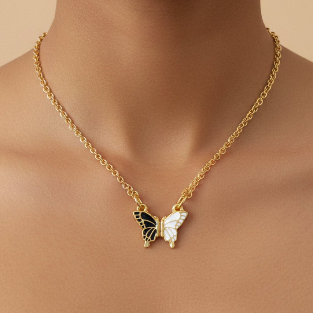 Gold necklace with a butterfly pendant on a beige background