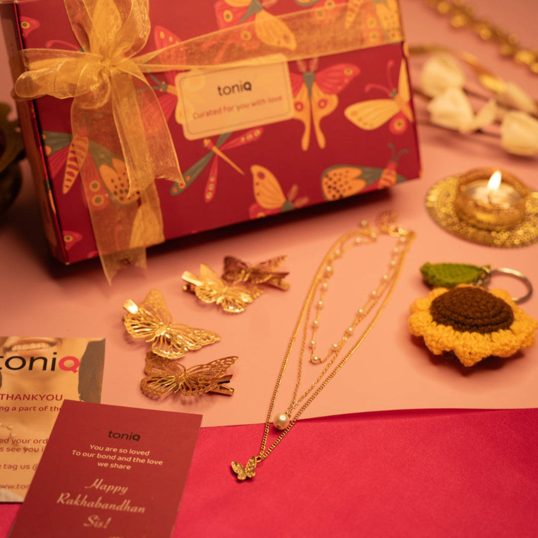 toniq jewelry set with butterfly designs on a red box and pink surface