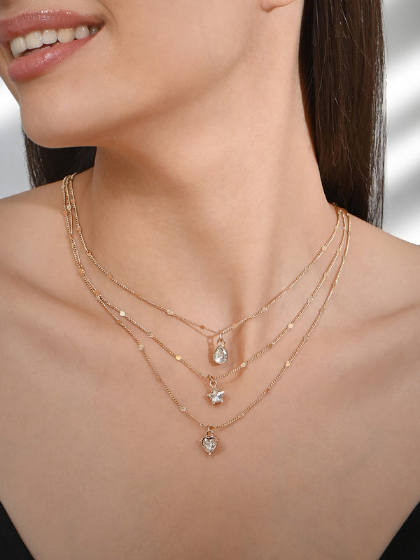 Three gold-colored layered necklaces with cubic zirconia stone pendants