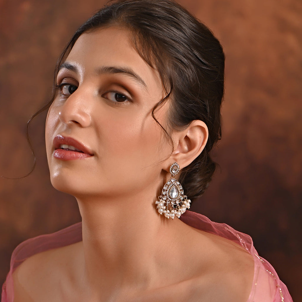 A pair of gold-plated ivory kundan stone drop earrings with ivory pearls