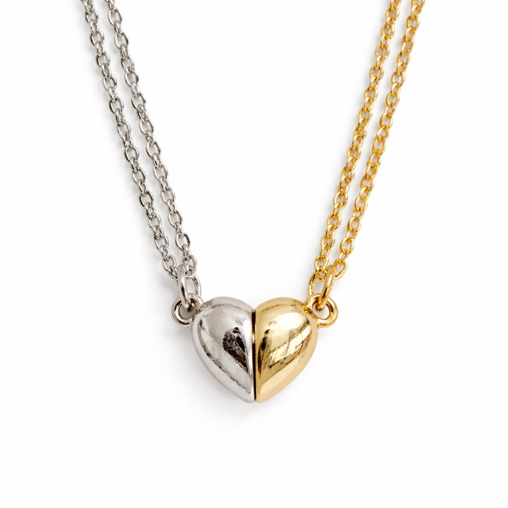 Two heart-shaped pendants on separate chains against a white background