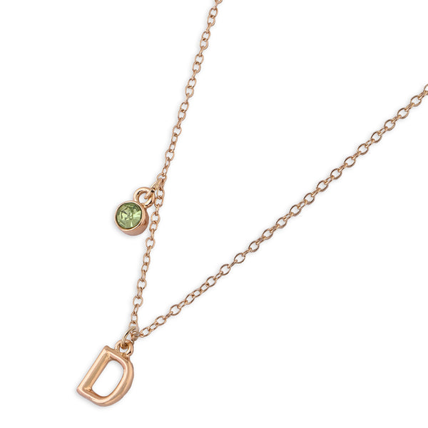 Gold necklace with a green gemstone and 'D' pendant on a white background