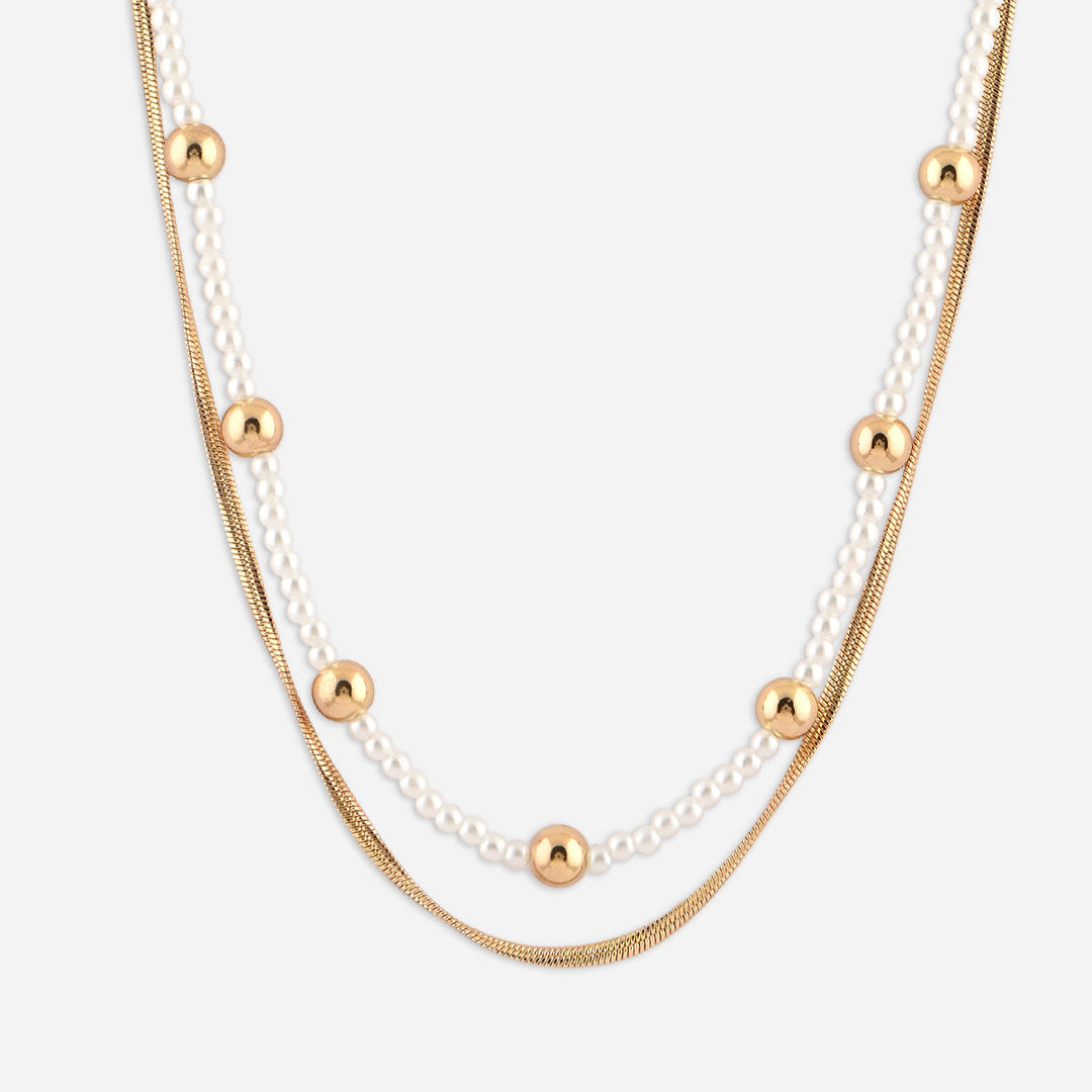 Layered necklace with gold and pearl beads on a white background