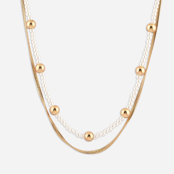 Layered necklace with gold and pearl beads on a white background