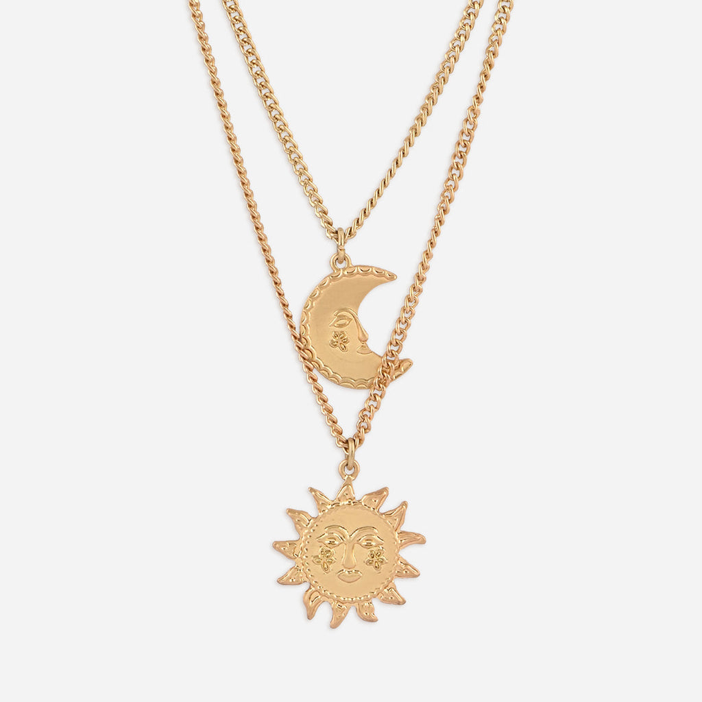 Gold necklace with sun and moon pendants on a white background