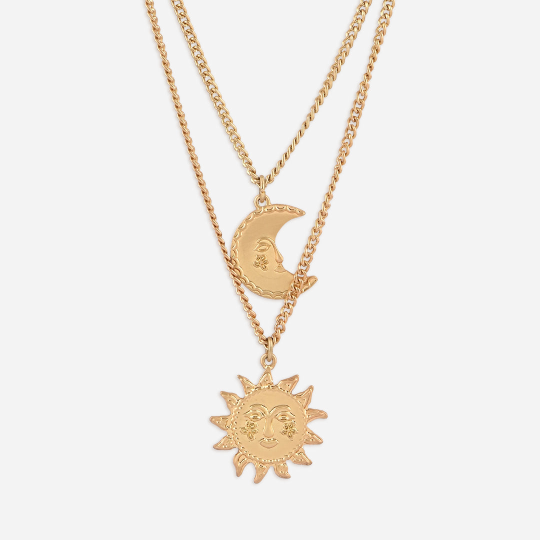 Gold necklace with sun and moon pendants on a white background