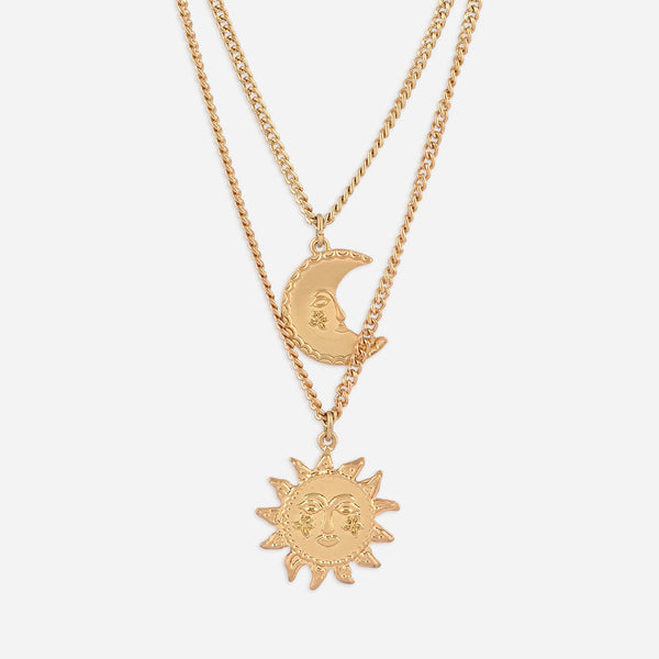 Gold necklace with sun and moon pendants on a white background