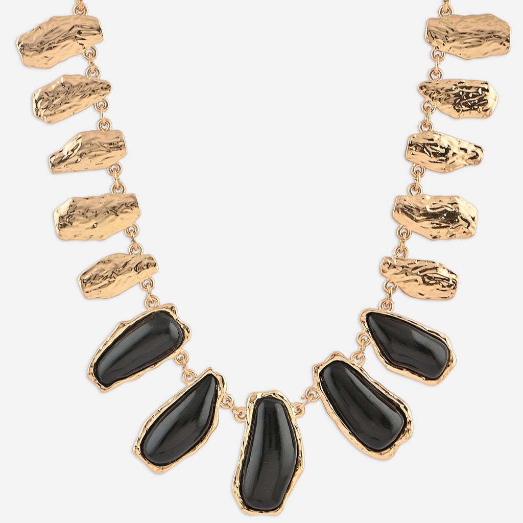 Necklace with gold and black stones on a white background