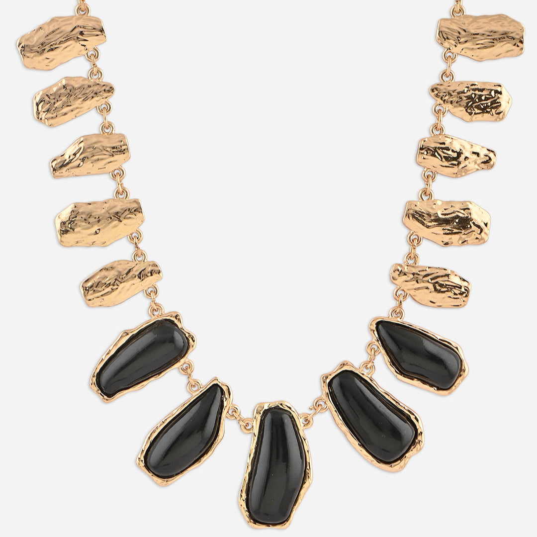 Necklace with gold and black stones on a white background
