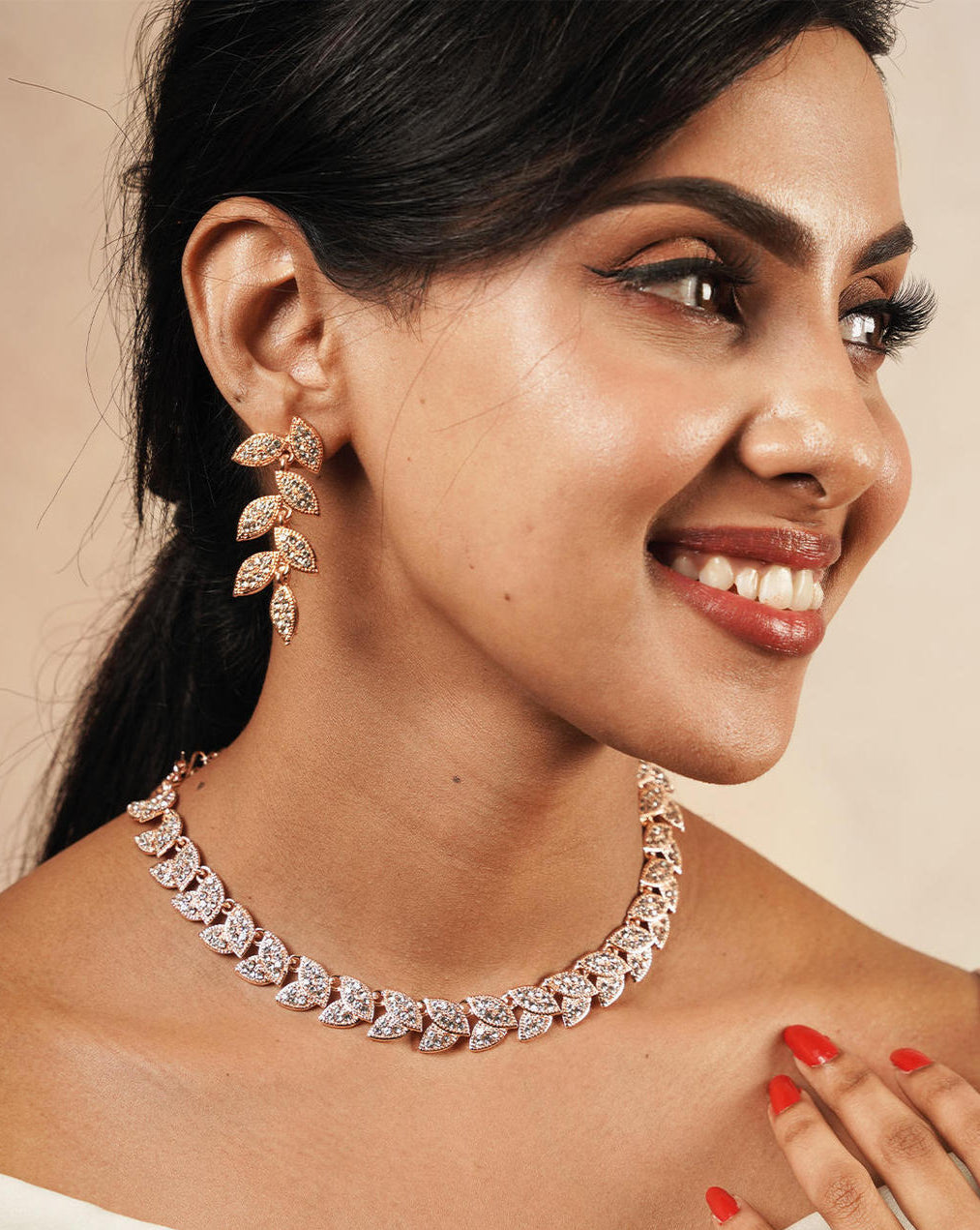 A rose gold plated alloy jewellery set featuring leafy shapes with American diamond