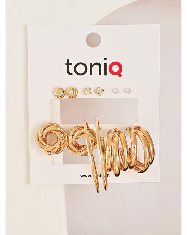 A set of six gold-plated white pearl earrings from Toniq, displayed on a card, with each earring designed in a unique shape.