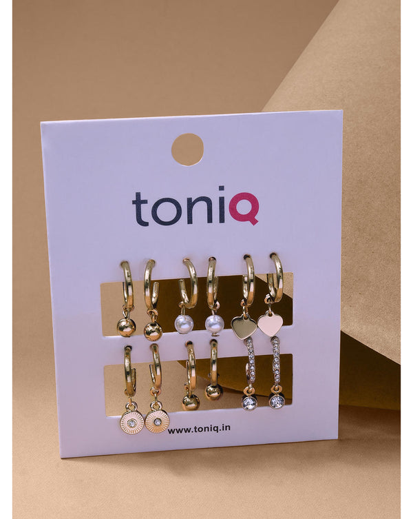 Collection of gold hoop earrings with various designs