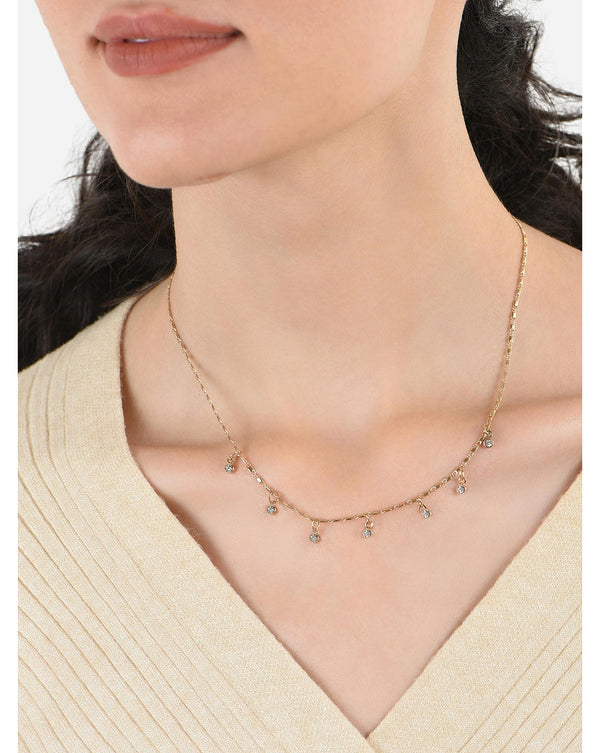 A woman wearing a gold plated alloy choker necklace with multiple charms and cubic zirconia stone accents.