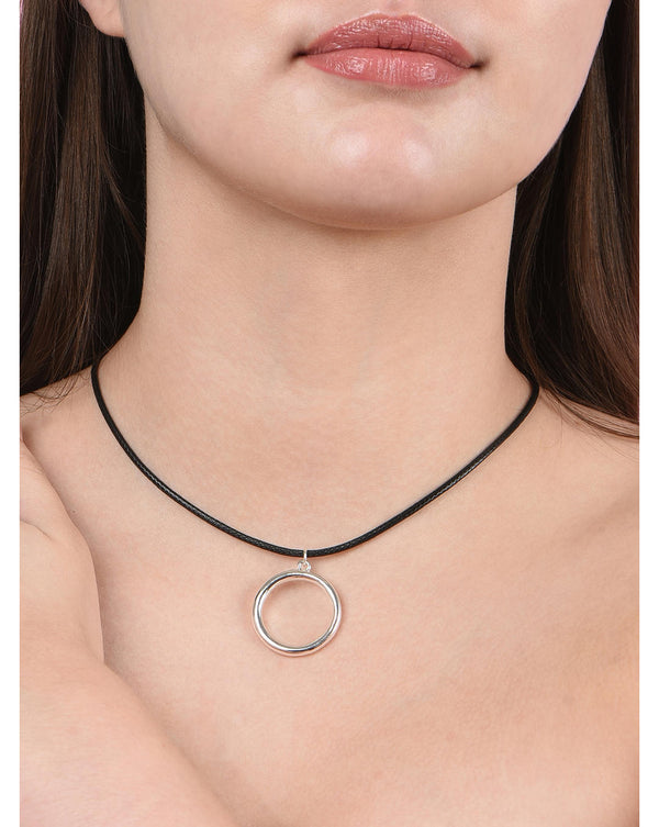 A woman wearing a silver and black round charm necklace.