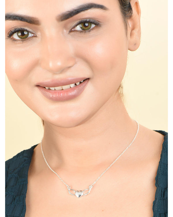 A woman wearing a silver plated angel charm necklace with a casual black top.