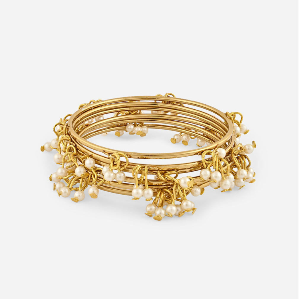 A gold-plated white pearl bangle, featuring a slip-on closure and ornamental pearl drops product image closeup with white background