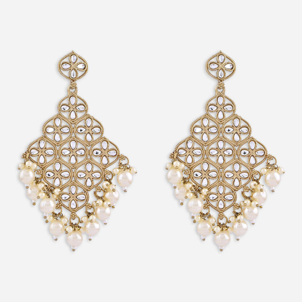 A pair of white kundan stone drop earrings with a traditional design.