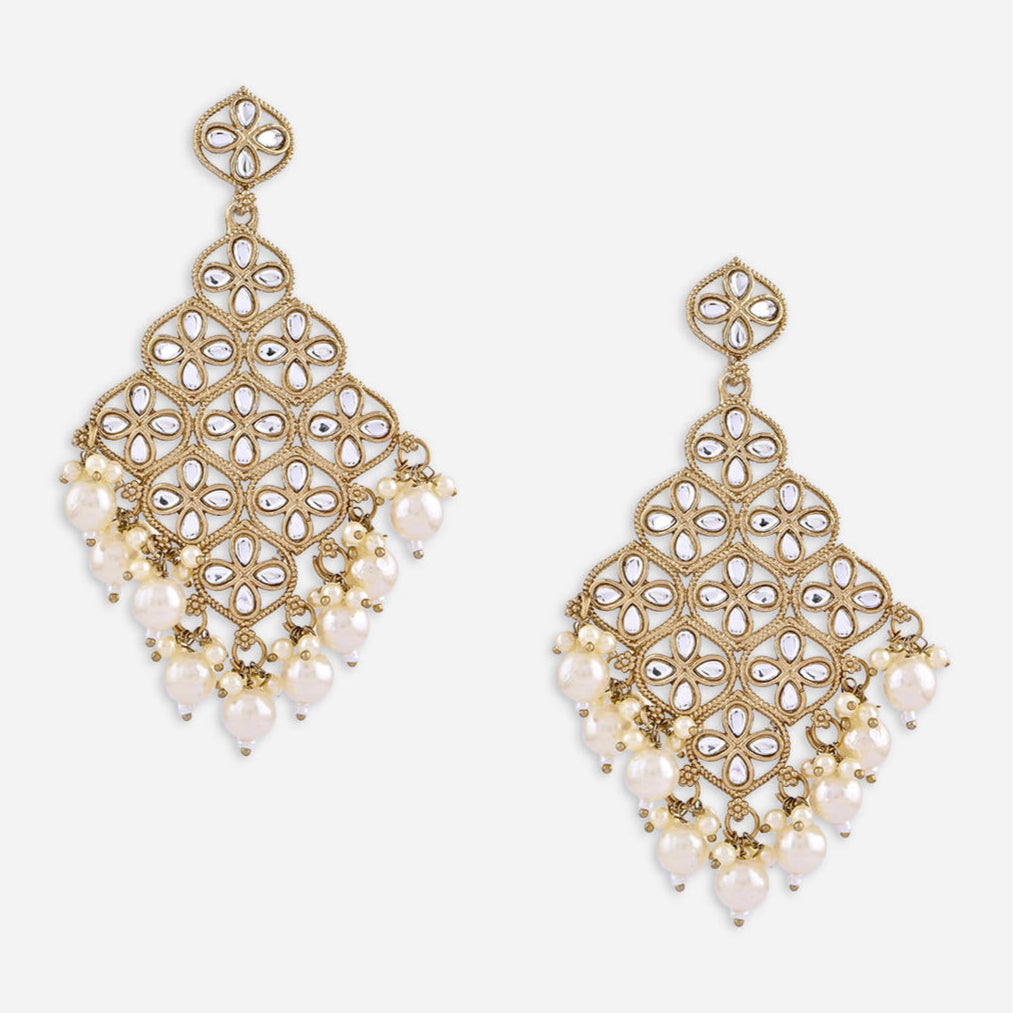 A pair of white kundan stone drop earrings with a traditional design.