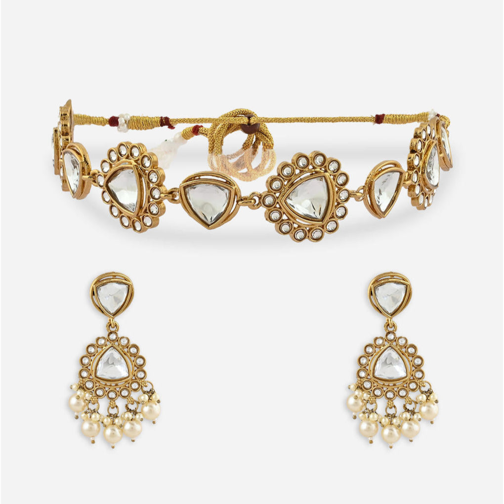 white pearl and kundan-studded bridal necklace, earrings, and a maang tikka set with white pearl and kundan-studded gold-plated designs.